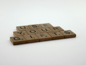 a wooden scrabble that says use your gifts